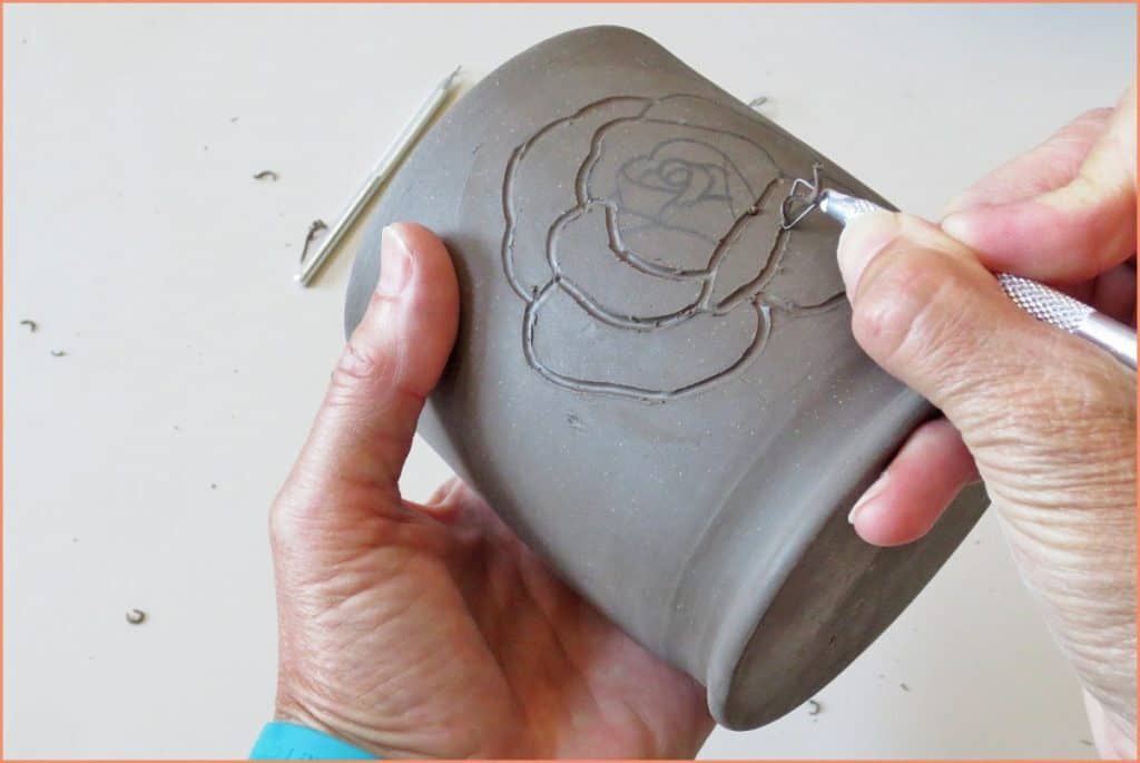 a picture of a potter using a ribbon tool