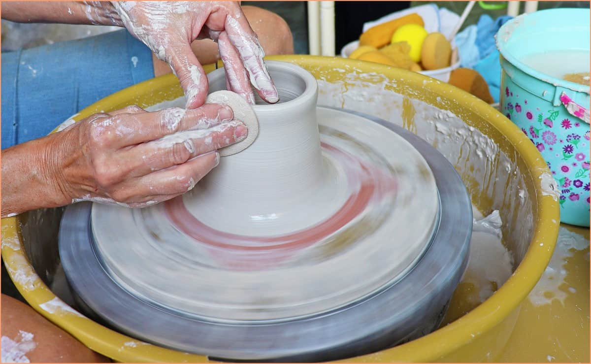 a picture of a potter throwing with a sponge