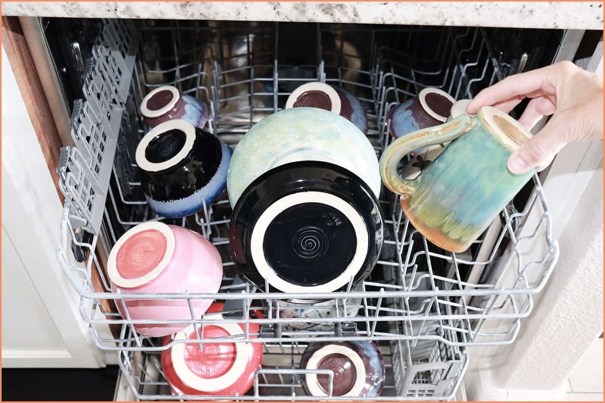 A picture of a potter Placing mug in dish washer