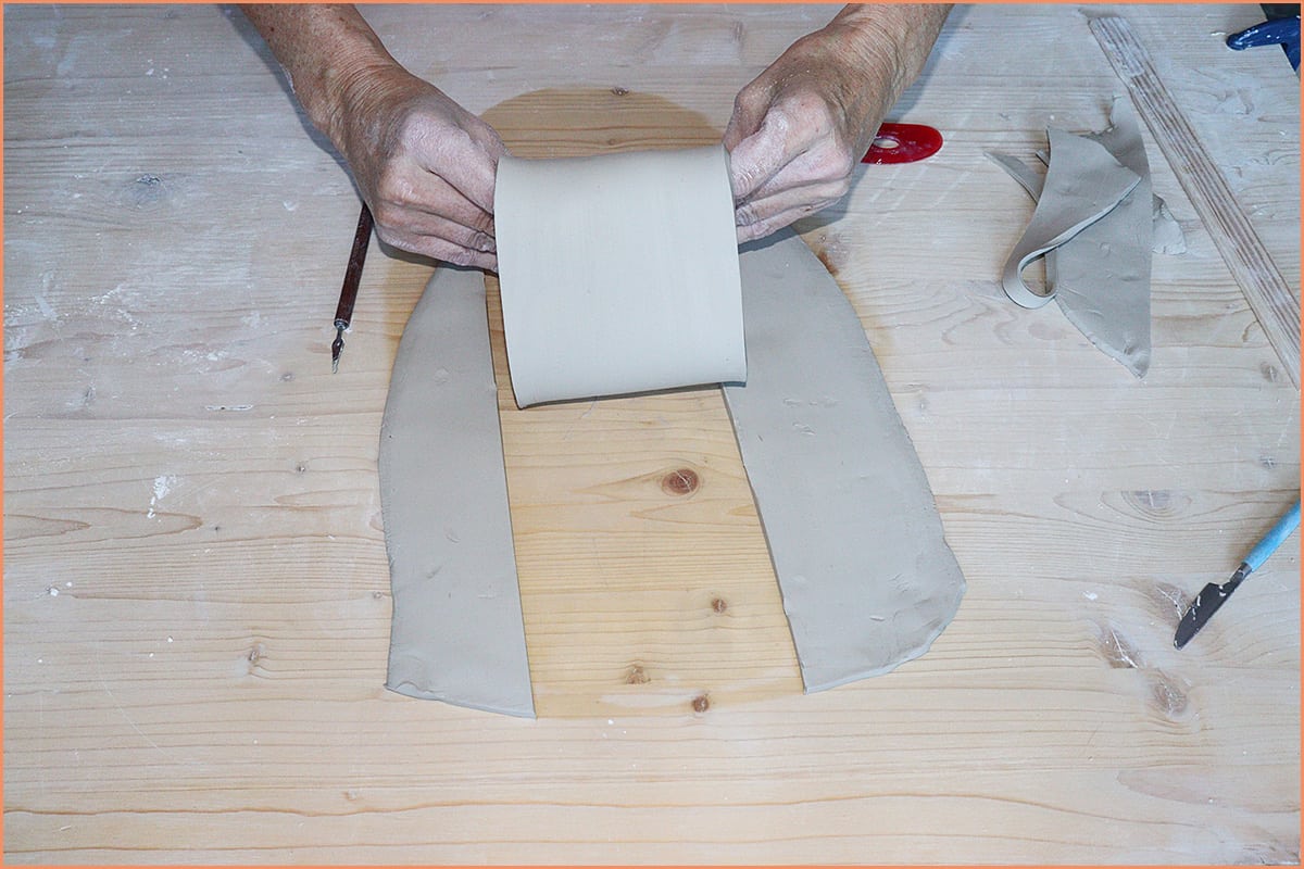 an image of a potter making a mug form