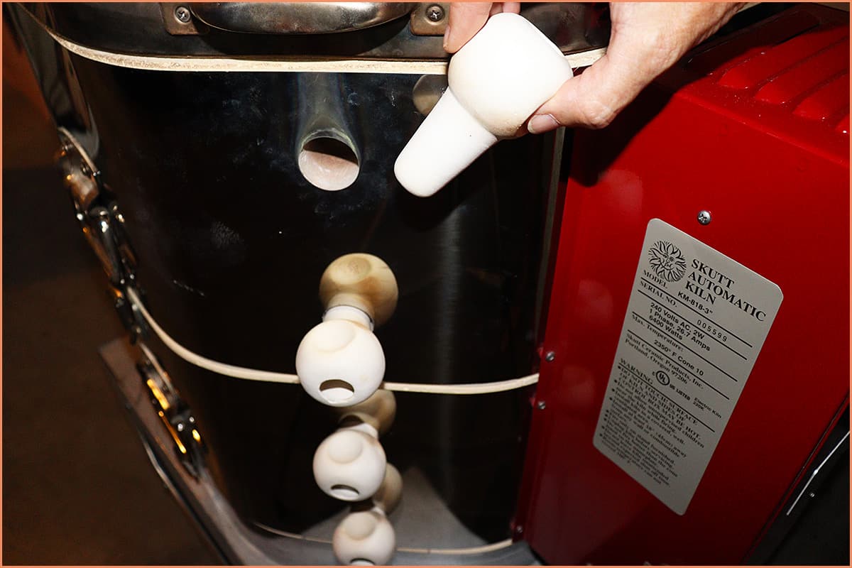 an image of a potter opening top peep hole