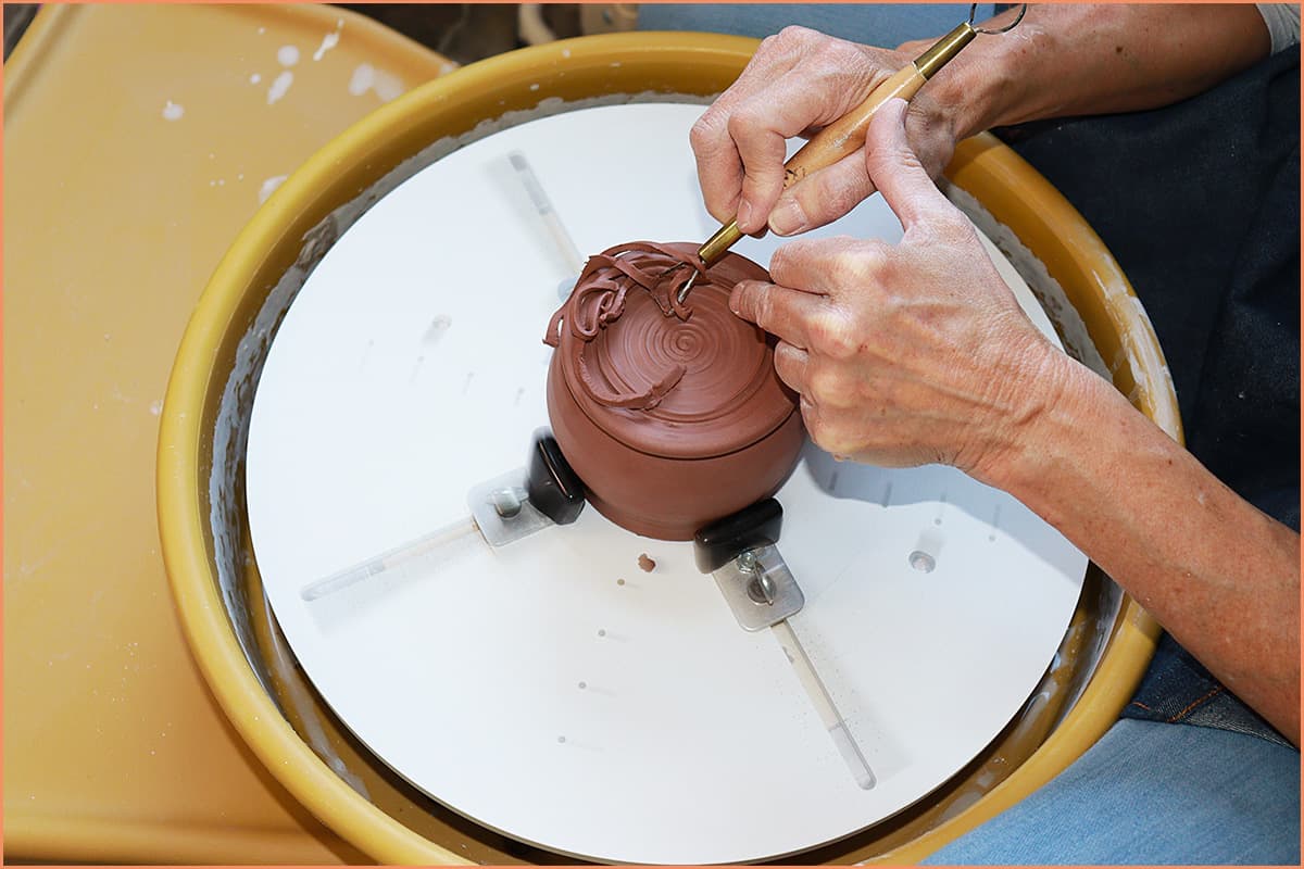 an image of a potter trimming Leather hard clay