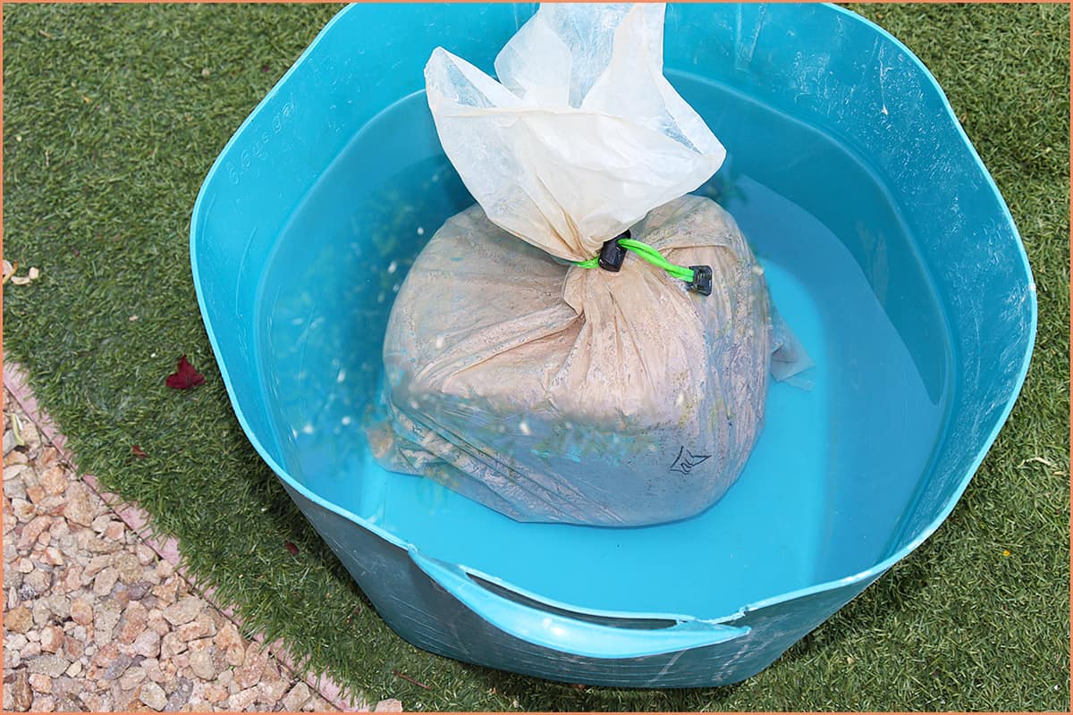 An Image of submerge the bag in a bucket of water