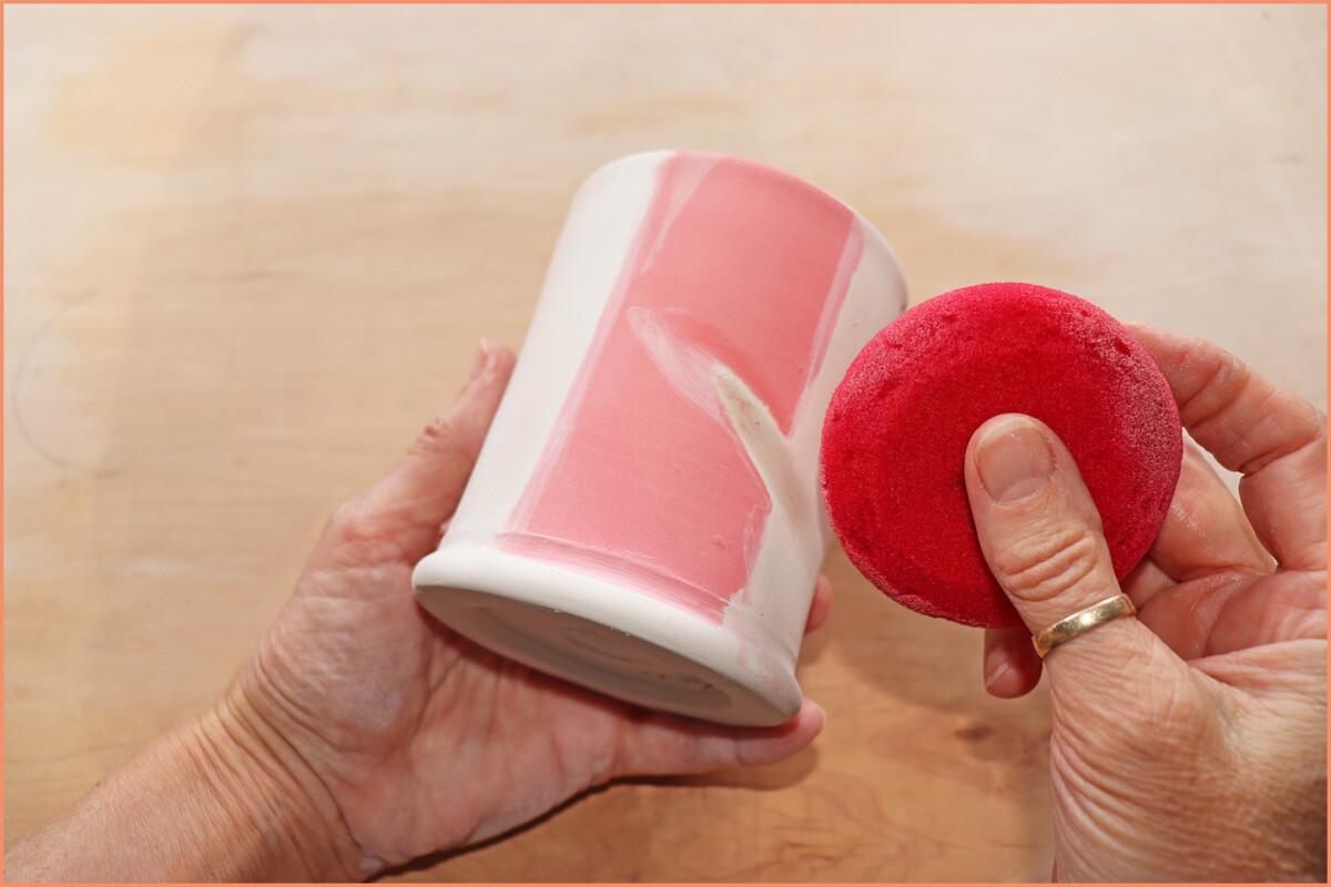 an image of a potter Removing underglaze from greenware